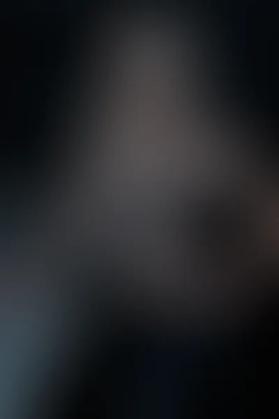 AI chainmail top sample — portrait of a woman standing side-on against a long chrome bar